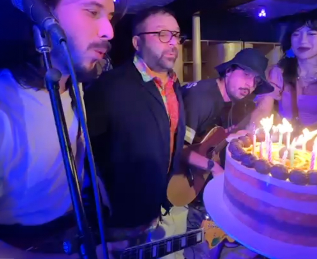 Musicians at BSMT254 blowing out candles to a cake